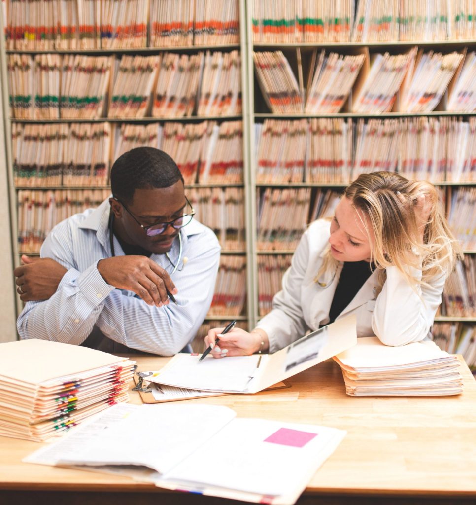 a man and woman looking at files